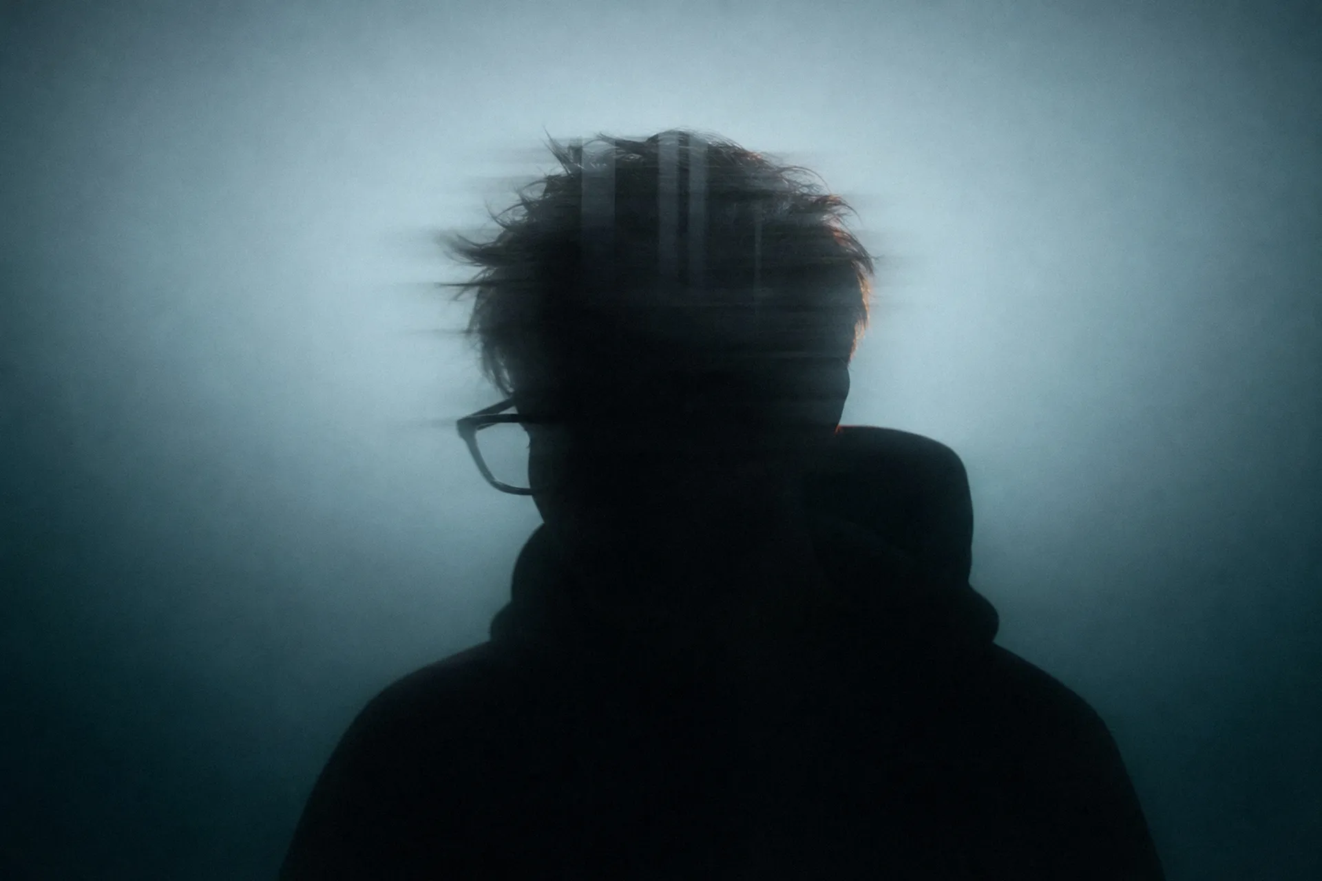 Silhouette of OnlyRodas in motion, backlit against a teal background
